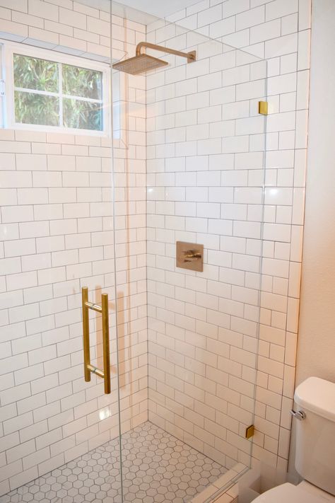 white subway tile shower with brushed gold fixtures White Tile Gold Fixtures, Shower With Gold Hardware, White Subway Tile Shower Gold Fixtures, White Subway Tile Bathroom Gold Fixtures, White Subway Tile Gold Fixtures, Shower Remodel Gold Fixtures, White Subway Tile Shower Brass Fixtures, White And Gold Bathroom Shower Ideas, Guest Bathroom With Gold Fixtures