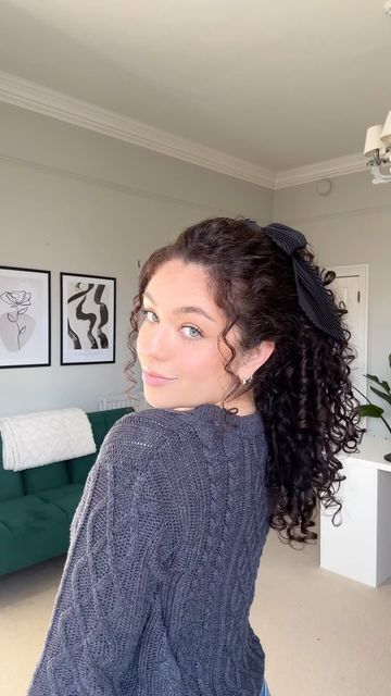 Sophie Marie on Instagram: "The cutest ponytail doesn’t exi… @sophiemariecurly 🖤🎬 Sharing one of my fave go-to easy hairstyles! A great hack if you want to make your hair look longer 😍🎀 Both the bow and clip are from @clairesstores 🏷️tag your curlfriends xoxo #curlyhairstyle #curlyhair #ponytail #hairtrends" Short Curly Hairstyles Ponytail, Curly Ponytail With Bow, Naturally Curly Ponytail, Curly Hair Bow Hairstyles, Curly Low Ponytail, Curly Hairstyles Ponytail, Clue Party, Curly Hair Ponytail, Brown Curly Hair