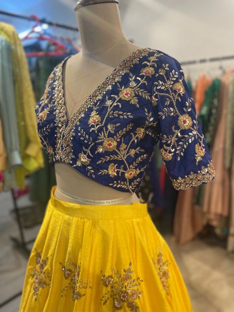 Royal blue deep v neck blouse with hand embroidered cutwork paired with sundhinr yellow color lehenga Yellow And Blue Lehenga, Royal Blue Blouse Designs, V Neck Lehenga Blouse, Customised Lehenga, Blue Work Blouse, Deep V Neck Blouse, Blue Blouse Designs, Fashionable Saree, Traditional Skirts