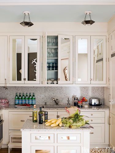 Antiqued mirrored glass on cabinet doors enlarges the small kitchen. Design: Jonathan Berger Mirrored Kitchen Cabinet, Easy Kitchen Updates, Mirrored Cabinet Doors, Over The Kitchen Sink, Kabinet Dapur, Small Space Design, Kitchen Cabinet Doors, Kitchen Pictures, Kitchen Mirror