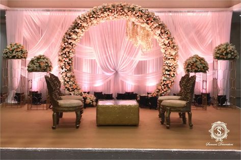 A customised peach colour theme curated for a wedding event. The mesmerizing drapes and floral decor is set to you soothe you for the evening.  #PinkTheme #Theme #DecorTheme #DecorIdeas #Decor #WeddingDecor #Weddings #CustomisedDecor Peach Stage Decoration, Peach Engagement Decoration, Tamil Engagement Decoration, Wedding Decor Stage, Peach And Mint Wedding, Mint Wedding Decor, Floral Arch Backdrop, Wedding Bg, Shadi Decor