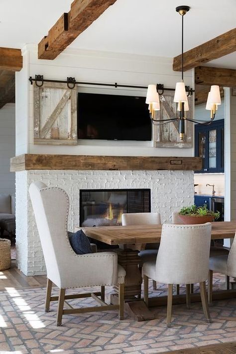 Modern Farmhouse Dining Room with Rustic Wood Beams, Mantel and Sliding Barn Doors to Cover the TV Rustic Wood Beams, Kitchen Dining Room Combo, Farmhouse Style Dining Room, Cottage Dining Rooms, Modern Farmhouse Dining Room, Wood Mantel, Dining Room Fireplace, Dining Room Paint, Double Sided Fireplace