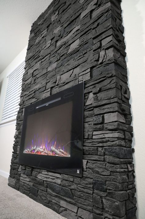 Black Rock Fireplace Stones, Black Stone Fireplace Ideas, Black Rock Fireplace, Genstone Faux Stone, Fireplace Stones, Lava Rock Fireplace, Faux Stone Fireplaces, Stone Electric Fireplace, Grey Stone Fireplace