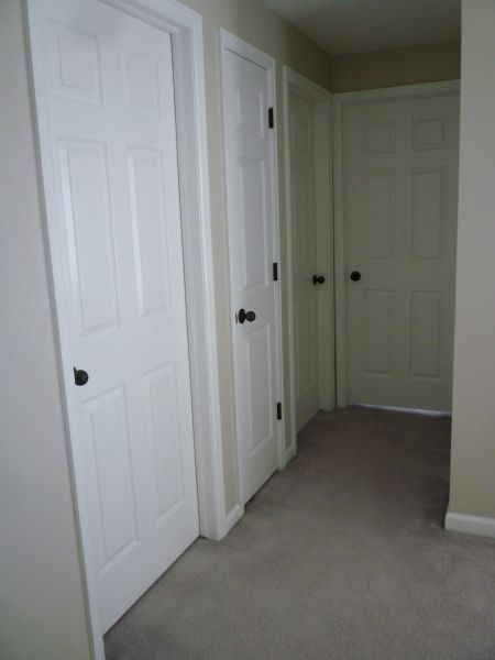 upstairs hallway after. Step by step reprinting door knobs. Remove first. Doors Painting, Black Interior Door, White Interior Doors, Black Door Knobs, Hallway Door, White Hallway, Interior Door Hardware, Closet Door Hardware, White Knobs