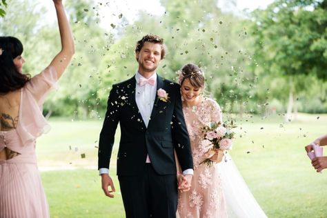 Romantic Modern Wedding at Badgemore Park With Pretty Pink Styling, A Pink Wedding Dress, Black and Pink Tuxedo and Pink Bridesmaid Dresses.  #laceweddingdress #pinkweddingdress #flowercrown #weddingmakeup #groom #pinkbowtie #confettishot Black And Pink Tuxedo, Romantic Modern Wedding, Groom Attire Black, Pink Tuxedo, Wedding Dress Black, Newly Wed, Pink Wedding Dress, Pink Bow Tie, Pink Bridesmaid Dresses