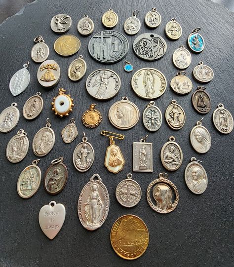 This is a large lot of vintage and antique Catholic Medals along with pins, brooches and pocket medals.  This is a great lot for assemblage art, jewelry, crafts or gifts. Please expect signs of age and use which is common to vintage items.  Thank you for visiting Vignette! Saint Medals, Orange City, Flower Carving, Catholic Medals, Floral Branch, Saints Medals, Gemstone Beaded Necklace, Rose Quartz Necklace, Sterling Silver Rings Bands