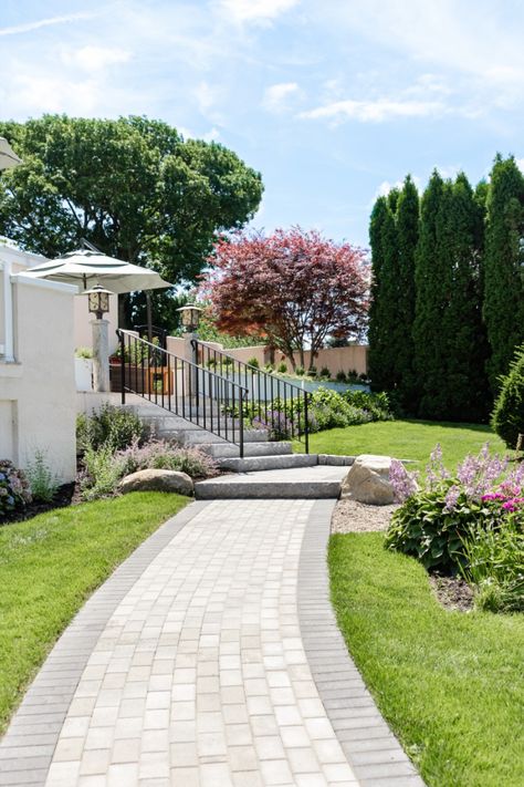 Running bond pavers create a long winding pathway through the manicured gardens of this Gloucester, MA property. Paved Walkway, Stone Patio Designs, Low Maintenance Yard, Pavers Backyard, Paver Walkway, Stone Landscaping, Front Walkway, Stone Patio, Cape Ann