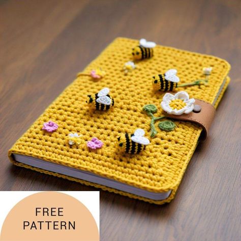 Bee Happy Colorful Buzzy Bee Notebook Cover pattern    This charming crochet notebook cover pattern  boasts a delightful bee design, featuring vibrant black and yellow stripes complemented by soft pastel blue wings. The bee’s whimsical charm is further accentuated by its shiny purple button eyes, adding a playful and eye-catching detail. The functional and textured beige cover beautifully blends utility with the cozy artistry of crochet, creating a piece that is both practical and full of charac Crochet Notebook Cover, Notebook Cover Pattern, Crochet Notebook, Bee Notebook, Crochet Book Cover, Buzzy Bee, Crochet Book, Easy Crochet Projects, Button Eyes