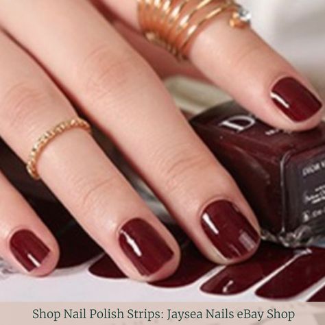 Closeup of dark maroon-brown manicured Nails resting atop a nail polish bottle filled with the same nail color and matching nail strips below the bottle. Fall Nails Easy, Nails With Polish, Mani Colors, Street Nail Art, Autumn Manicure, Short Nail Manicure, Fall Acrylic, Wide Nails, Nail Polish Colors Fall