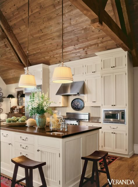 This rustic kitchen features a sloped wooden ceiling leading to beadboard cabinets and island with chopping-block top, all by Wood-Mode.   - Veranda.com Beadboard Cabinets, Wooden Ceiling, Cabin Kitchen, Farmhouse Kitchen Cabinets, Cabin Kitchens, Wood Ceiling, Rustic Farmhouse Kitchen, Wooden Ceilings, Wood Ceilings