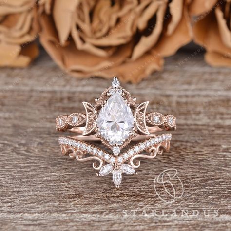 Unique Pear Shaped Moissanite Engagement Ring Set 2PCS Rose Gold Marquise Wedding Band Women Moon Ring Vine Flower Ring Bridal Set Milgrain * Ring Material: solid 14k rose gold, yellow gold and white gold  * Center Stone: Colorless Moissanite, in Pear  * Center Stone Size: 6x8mm / 1.2ct  * Side Stone: Natural Diamond or Moissanite, about 0.2ct * Bandwidth: 1.5mm * Buy them separately:  Engagement ring: https://www.etsy.com/listing/1588933506 2-3 WEEKS PROCESSING TIME MADE IN US * Shipping * FREE Moissanite Bridal Ring Sets, Wedding Rings With Vines, Vintage Black Wedding Ring, Nested Wedding Band, Vintage Pear Ring, Unique Wedding Rings Engagement Bridal Sets, Pear Shape Rings, Engagement Rings Teardrop, Wedding Rings Engagement Gold