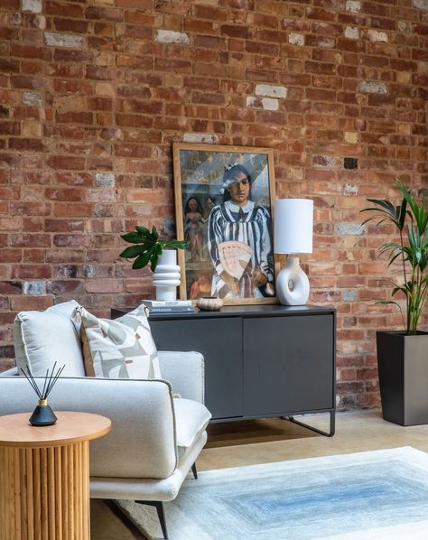 Happy Monday! What do you guys think of this warehouse interior I designed? 🛋 The client loved the exposed brick but wanted a calming, neutral space. I softened the harshness of the red brick with soothing blue tones and whites. We left the walls bare for renter-friendly versatility. What do you think? If you like what you see: Armchair: @daals.co.uk Rug: @dunelmuk Cushion: @nextofficial Side Table: @dunelmuk Sideboard: Client's own #KnookInteriors #ApartmentDecor #ApartmentLiving #In... Exposed Red Brick Living Room, Red Brick Feature Wall, Red Brick Wallpaper Living Room, Red Brick Wallpaper Bedroom, Red Brick Wall Aesthetic, Warehouse Interior, Three Seater Sofa Bed, Red Brick Walls, Neutral Sofa