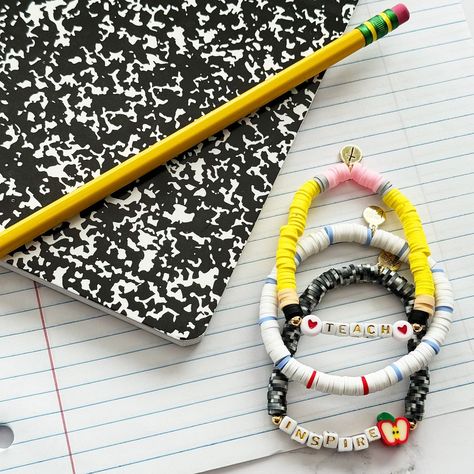 It’s back to school month!! 🍎✏️📓Which means…new items headed your way! First up - First day of school teacher gift! This set of 3 bracelets will come on a cute card and fun ribbon to attach! $35 for the set! First Day Of School Teacher, Teacher Bracelet, Cake Banner Topper, Kids Notebook, Paper Gift Tags, School Teacher Gifts, A Pencil, Crafty Craft, Bracelet Collection