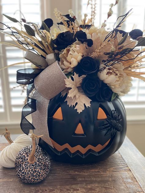 Add some Falloween to your holiday decor. This luxurious neutral giant Jackolantern is sure to impress your guests with its beautiful flowers, designer ribbon adorning a one of a kind black pumpkin.  XL design measuring 28" tall and 26" diameter.  Needs access to wall outlet to light up.  FREE LOCAL PICKUP: If you are local to Katy, TX, I offer free porch pick up to save on shipping. Please DM for code to take off shipping.  Any overages on shipping will be refunded Excluded from FREE SHIPPING O Black Pumpkin Decor, Haunted House For Kids, Creative Halloween Decorations, Halloween Pumpkin Crafts, Pumpkin Planter, Giant Pumpkin, Fake Pumpkins, Halloween Flowers, Fall Thanksgiving Wreaths