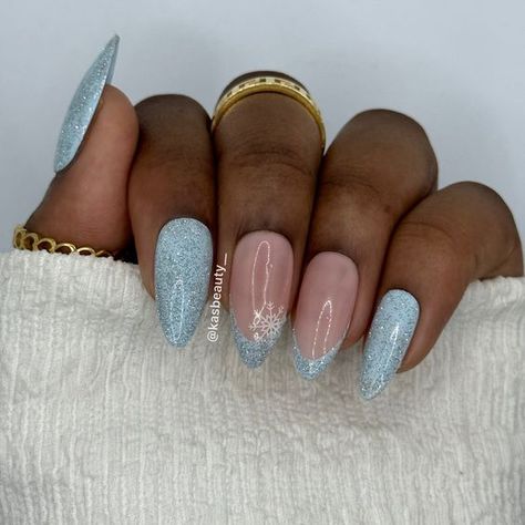 15 Winter Nail Ideas for Dark Skin Tones in 2023-2024 - thepinkgoose.com Icy Gel Nails, Glitter Light Blue Nails, Blue Christmas Nails 2023, Light Blue Glitter French Tip Nails, Blue Icy Nails, Wintery Blue Nails, Light Blue Nails With Snowflakes, Winter Blue Nails Acrylic, Blue Medium Nails