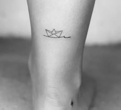 50 Outstanding Boat Tattoo Ideas that You Have To Notice! - Tattoo Twist Small Sailing Tattoo, Mini Sailboat Tattoo, Minimalist Ship Tattoo, Paper Boat Tattoo Small, Small Boat Tattoo Simple, Tiny Ship Tattoo, Paper Boat Tattoo Design, Boating Tattoo Ideas, Fine Line Boat Tattoo