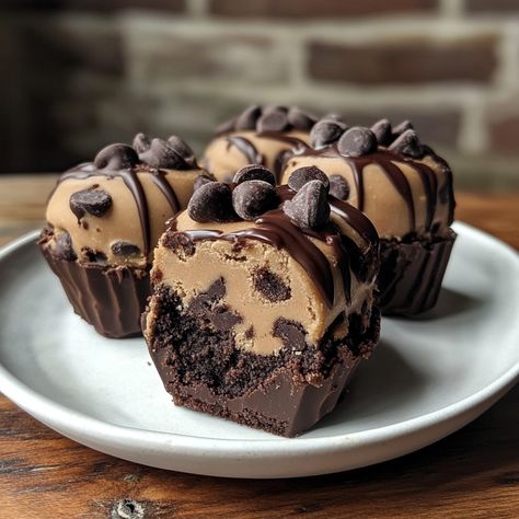 Chocolate Chip Cookie Dough Brownie Bombs 🍪🍫 Ingredients: For the Cookie Dough: 1/2 cup unsalted butter, softened 1/2 cup brown sugar 1/4 cup granulated sugar 2 tbsp milk 1 tsp vanilla extract 1 cup all-purpose flour (heat-treated) 1/2 cup mini chocolate chips For the Brownies: 1 box brownie mix 1/4 cup water 1/2 cup vegetable oil 2 large eggs For the Coating: 2 cups semi-sweet chocolate chips 1 tbsp vegetable oil Instructions: Make the Cookie Dough: In a bowl, beat butter, brown sugar, and g... Chocolate Chip Cookie Dough Brownies, Cookie Dough Cupcakes, Chocolate Deserts, Mini Brownies, Yummy Comfort Food, Delicious Snacks Recipes, Brownie Mix, Chocolate Chip Cookie Dough, Sweet Chocolate