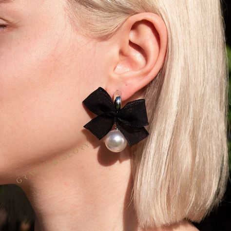 when your outfit needs the perfect finishing touch: Our super cute Bow Pearl Earrings are perfect to add a little glamour to your everyday look. These earrings are made from a genuine organza satin stacked below an acrylic pearl . Measures 1 1/2" by 2". Surgical steel post.  * Organza Satin Bow * Acrylic Pearl * Surgical steel post * Postback * One size. SIZE * Measures 1 1/2" by 2" * Width, about 0.5" Comes packaged in our signature velour dust bag. Bow Earring, Prom Hair Accessories, Silver Hair Clip, Acrylic Earring, Pearl Bow, Earrings Acrylic, Silver Bow, Steel Post, Earrings Pearl