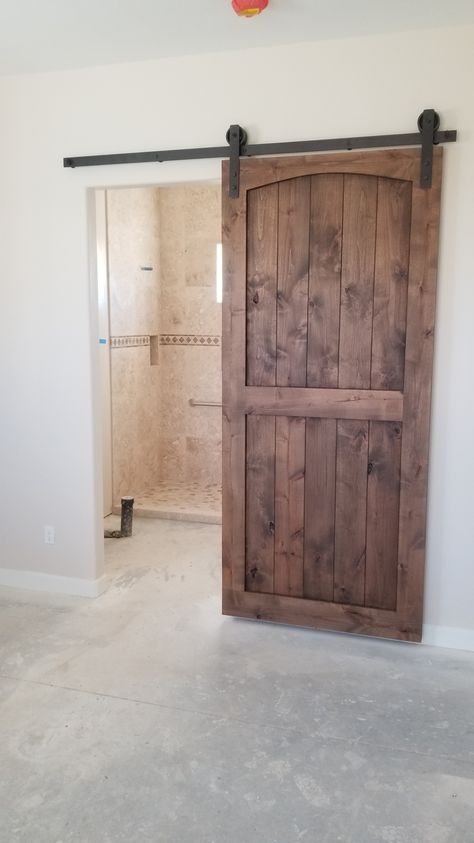 Knotty Alder Eyebrow arch barn door Rustic Barn Doors In The House, Stained Barn Doors, Barn Doors In The House, Arched Barn Door, Arched French Doors, Eyebrow Arch, Knotty Alder Doors, Wooden Barn Doors, Village Square