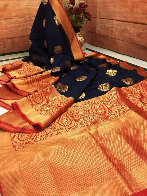 Show your iconic look as you deck up with this stunning Navy Blue and Red combination pure Kora Silk Banarasi Saree. Crafted from fine silk, this saree is extremely comfortable and flaunts traditional Banarasi Golden Zari butta all over the body and an intricately weaved paisley border. This saree also showcases glamor Deep Orange Color, Red Combination, Paisley Border, Saree Tassels Designs, Blue Silk Saree, Silk Banarasi Saree, Banaras Sarees, Kora Silk Sarees, Modern Saree