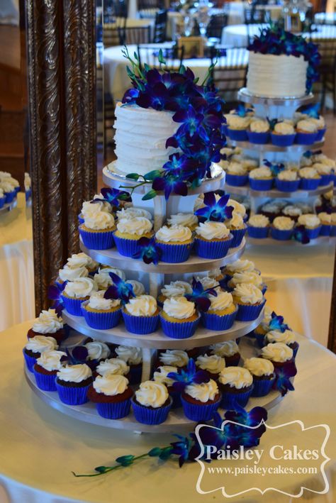 Royal Blue and Purple Cupcake Tower Wedding Cake with Orchids. Made by Paisley Cakes, Blackfoot Idaho. Cake With Orchids, Blue Wedding Cupcakes, Royal Blue Wedding Cakes, Paisley Cake, Royal Blue Wedding Theme, Wedding Cake Options, Cupcake Tower Wedding, Blue Wedding Decorations, Purple Cupcakes