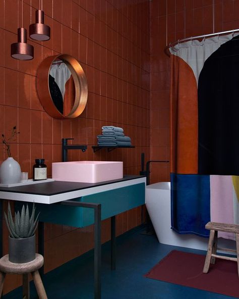 a bold color blocked bathroom with a rust wall, a pink sink, a teal vanity and a color blocked shower curtain to match Geometric Bathroom, Unique Bathrooms, Amazing Apartments, Colorful Bathroom, Colorful Interior, Scandinavian Bathroom, Deco Bathroom, Bad Inspiration, Wall Shelves Design