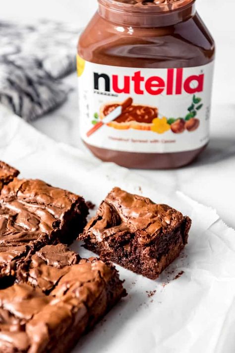 These rich, deeply chocolatey Nutella Brownies are a home run dessert for anybody who loves the indulgent chocolate hazelnut spread. Not only is the brownie batter made with Nutella, but then more of it is dropped on top and swirled in for pockets of concentrated Nutella goodness! #brownies #nutella #recipe #best #chocolate #hazelnut #swirled #homemade Pecan Pie Cake Recipe, Pie Cake Recipe, Nutella Recipes Brownies, Chocolate Walnut Fudge, Pecan Pie Cake, Nutella Recipes Easy, Walnut Fudge, Chocolate Chip Pecan Cookies, Resep Brownies