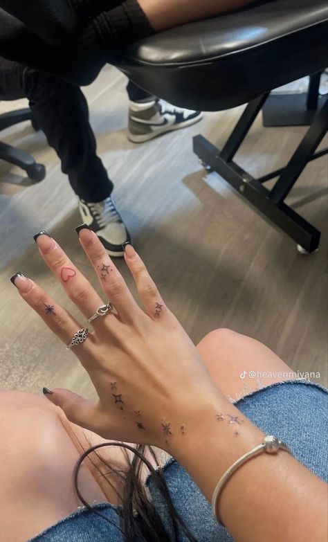 Small Star Tattoos On Hand, Tiny Stars Tattoo Hand, Sparkle Tattoos On Hand, Subtle Leg Tattoos, Stars Hand Tattoos For Women, Libra Constellation Tattoo Hand, Twinkle Hand Tattoo, Hand Sparkles Tattoo, Finger Tattoos Sparkle