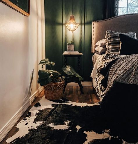 Moody Bedroom with Green Accent Wall and Cowhide Area Rug Moody Emerald Bedroom, Emerald Green Western Bedroom, Dark Green Western Bedroom, Western Green Bedroom, Bedroom With Cowhide Rug, Black And Green Home Decor, Dark Guest Bedroom, Moody Western Bedroom, Green Western Aesthetic