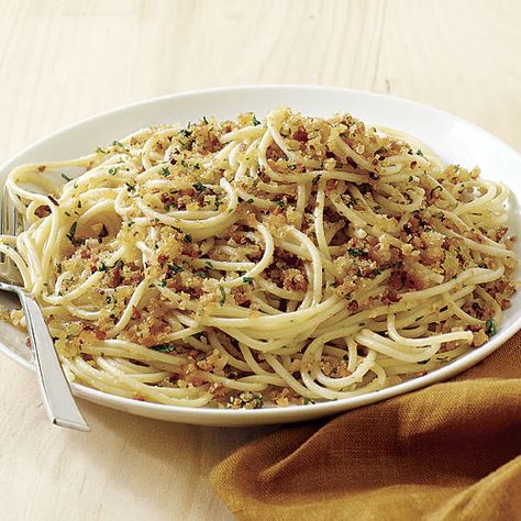 This is a twist on spaghetti aglio e olio, a traditional Italian pasta dish featuring garlic, olive oil, and chile. The fresh breadcrumbs soak up the spicy oil and garlic in a most delicious way. Be sure to brown the breadcrumbs well, or they’ll be soggy in the finished dish. Ciabatta breadcrumbs are best for this dish, but you can use any mild-flavored bread; leave the crusts on for the best texture. The anchovies are optional, but they bring complexity to the dish without making it taste ov... Flavored Bread, Anchovy Pasta, Spaghetti Aglio, Pasta Italiana, Olive Oil Recipes, Italian Pasta Dishes, Fine Cooking, English Muffins, Fresh Pasta