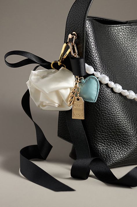 Charming new-trend alert: jewelry for your bag, featuring a long pearl chain to extend across your bag. | Pearl Chain Bag Charm by Anthropologie in White, Women's, Brass/Resin Purse Accessories Ideas, Holiday Wishlist, Animal Bag, Bow Bag, Metallic Bag, Bag Charms, Bag Ideas, Bag Chain, Feather Charms