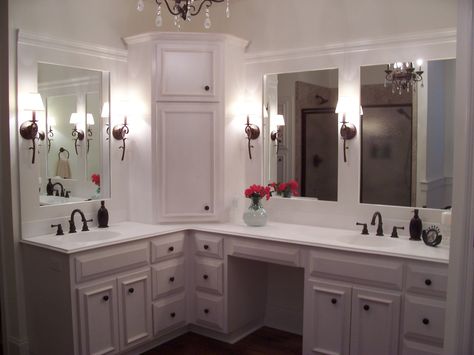 Custom built home - Master Bathroom with custom white cabinets. Corner Linen Tower. Beautiful trim on mirrors oil rubbed bronze wall sconces. Vanity has make up area.  Visit us at stevecoxinc.net Vanity With Linen Cabinet, Corner Bathroom Vanity, Cabinet Trends, Corner Bathroom, Corner Vanity, Custom Bathroom Vanity, Room Vanity, Custom Bathroom, Bathroom Reno