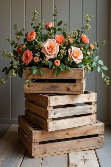 Explore 22 rustic wedding ideas that stylishly blend natural and vintage elements. The pin features wooden crates for decor, a great example of how to create a charming celebration. Wood Crate Centerpiece, Rustic Wedding Floral Centerpieces, Barrel Centerpiece Wedding, Wine Crate Wedding Decor, Basket Centerpieces Table Wedding, Rustic Boho Wedding Decor Table Settings, Rustic Wedding Floral Arrangements, Wooden Crate Wedding Decor, Wood Box Ideas Decor