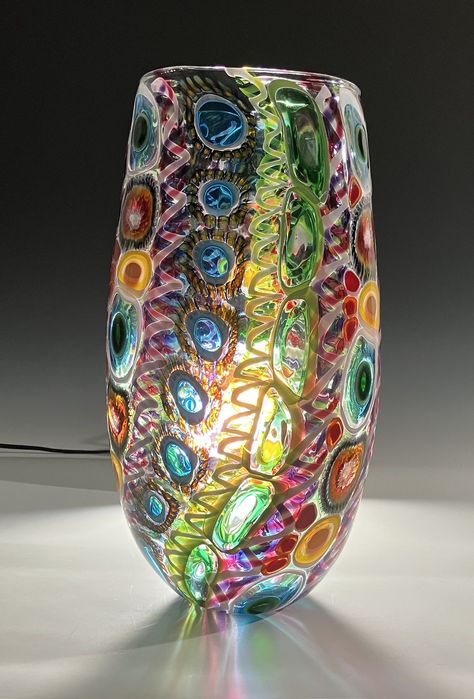 This vivid, hand-blown vase is absolutely bursting with movement. Featuring murrini and dazzling canework, John captures the undulating movements of waves and tide pools, with anemone-like patterns creating small windows into the vase which allow other colors to shine through. Perfect for displaying as a centerpiece, or as part of your colorful vessel collection. This beautiful piece measures 18 inches in height and 8.75 width. Anemone Coral, Sea Collage, Contemporary Vases, Fused Glass Art, Vases And Vessels, Glass Artists, Coral Reef, Lampwork Beads, Anemone