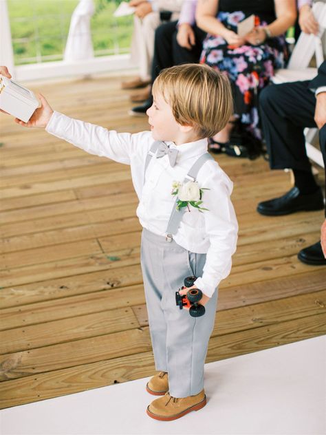 real wedding photo at sassafras springs vineyard arkansas ring bearer in grey pants suspenders and bow tie toy car Light Grey Ring Bearer Outfit, Ring Bearer Gray Outfit, Ring Bearer Ideas Boys, Ringer Bearer Outfit, Ring Barrier Ideas Boys, Gray Ring Bearer Outfit, Ring Boy Wedding, Ring Bearer Outfit Grey, Ring Bearer Ideas