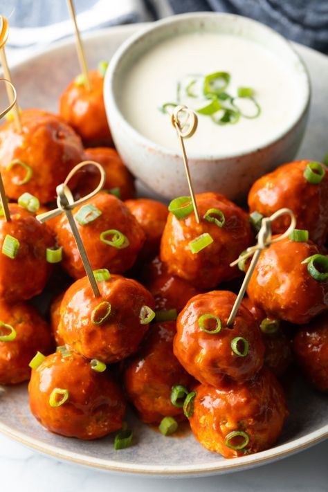 Plate of buffalo chicken meatballs skewered with serving toothpicks, nestled next to a white dish of ranch dressing dipping sauce. Buffalo Meatballs, Meatball Skewers, Chicken Meatballs Recipe, Ranch Dressing Dip, Chicken Skewer Recipe, Buffalo Chicken Meatballs, Chicken Wing Sauces, Chicken Meatball Recipes, Spicy Wings