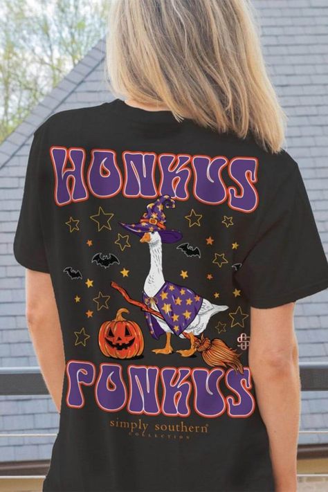 This Simply Southern Honkus Ponkus Halloween Goose T-Shirt for Women in Black is perfect for this spooky season. This shirt features an adorable graphics, short sleeves, and lightweight construction. Features: Simply Southern Style: SS-GOOSEWITCH-BLACK Color: Black 100% Cotton Simply Southern Shirts Short sleeves, crew neckline Simply Southern logo graphic on the front On the front: Goose wearing a witch hat with stars On the back: “Honkus Ponkus” with a goose with a witch hat on a broom stick, surrounded by stars and a Jacko lantern, along with the Simply Southern logo. Measurements from size small: Length from back shoulder: 27” Chest: 36” Machine wash cold, tumble dry low Southern Logo, Broom Stick, Simply Southern Shirts, Women In Black, A Broom, Southern Shirts, Judy Blue Jeans, Boutique Tops, Simply Southern