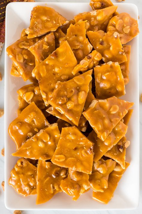 This easy peanut brittle recipe is golden, buttery, and perfect as a treat or to package up for holiday gifts. This homemade candy is salty and sweet and only has six ingredients! | www.persnicketyplates.com See's Peanut Brittle Recipe, Easy Peanut Brittle, Easy Peanut Brittle Recipe, Peanut Clusters In Crockpot, Mexican Wedding Cookies Recipes, Homemade Peanut Brittle, Old World Garden, Arepas Recipe, Easy Christmas Candy Recipes