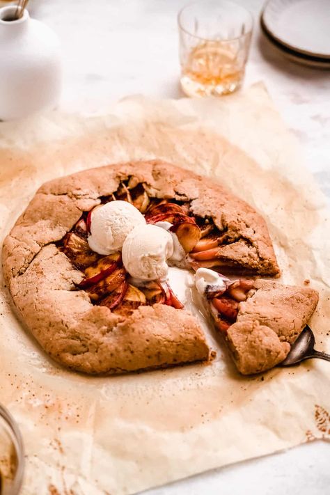 This cozy vegan bourbon apple galette has all the flavors of a delicious apple pie but without all the fuss. It has a crispy sweet crust holding together bourbon infused baked apples all topped off with a scoop or two of ice cream. Made with gluten-free and paleo-friendly ingredients, it simply must be on your fall baking list. Gluten Free Galette, Traditional Apple Pie, Baking List, Dessert Hummus, Hearty Snacks, Apple Galette, Gluten Free Pie, Fall Baking, Baked Apples