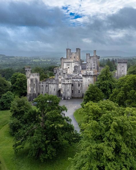 Penrhyn Castle is an imposing nineteenth-century castle set in the beautiful countryside of North Wales. Built between 1820 and 1833 in neo-Norman style, to the design of Thomas Hopper. It is a blend of medieval and Victorian architecture. The castle was built by the Pennant family, who made their fortune in the sugar and slate industries. This gave the castle not only its luxurious appearance but also a controversial background. When visiting Penrhyn Castle, you can enjoy the impressive in... Penrhyn Castle, Lindisfarne Castle, Small Museum, Vintage Castle, Penn Station, Beautiful Countryside, Railroad History, Cathedral Architecture, Architecture Ideas