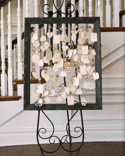 Unique Wedding Guest Book Ideas That Aren't Actually Books | Martha Stewart Weddings - In honor of her husband's heritage (he's from France), this bride thought to use love locks instead of a traditional guest book. Celebrants sealed their notes to this display. #guestbookideas #uniqueweddingideas #weddingguestbook Library Card Wedding Guest Book, 50th Wedding Anniversary Guest Book Ideas, Graduation Guest Signature Ideas, Birthday Guest Sign In Ideas, Guest Book Ideas For Small Wedding, 80th Birthday Party Guest Book Ideas, Wedding Table Guest Book, Alternative To Wedding Guest Book, Alternate Guest Book Ideas