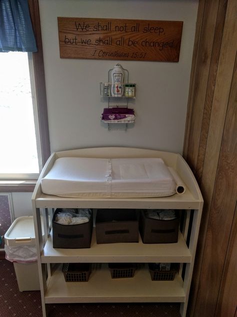 I redid our small church nursery for under $100! I painted an old wooden changing table white, utilized a shower caddy, and bought bins from the Dollar store! Reuse, recycle and craft! Clean and simple is the way to go, less clutter and more play room! Love it! #gray #white #smallchurch #nursery #makeover #clean Church Nursery Ideas, Church Nursery Organization, Church Nursery Decor, Kids Church Rooms, Tiny Nursery, Nursery Makeover, Nursery Preschool, Nursery Changing Table, Baby Changing Station