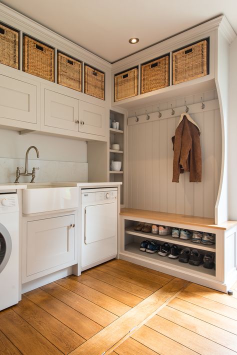 In this utility boot room has been designed with storage in mind. The upper tier cabinets were designed to take a selection of storage baskets, while the tall counter slim cabinet sits in front of a pipe box and makes a great storage space for the client's selection of vases.  Shoes are neatly stored out of the way with a bench in Oak above for a seated area. Mudroom And Laundry Room Combo, Basement Mudroom, Utility Boot Room, Slim Cabinet, Boot Room Utility, Country Laundry Rooms, Utility Room Storage, Small Utility Room, Utility Room Designs