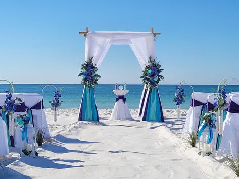 Wedding Arch Beach Ideas, Beach Flower Arch Wedding, Simple Beach Arch Wedding, Under The Sea Wedding, Beach Wedding Arch With Chandelier, Beach Floral Arch, Destination Wedding Reception Decor, Purple Turquoise Wedding, Outdoor Evening Wedding