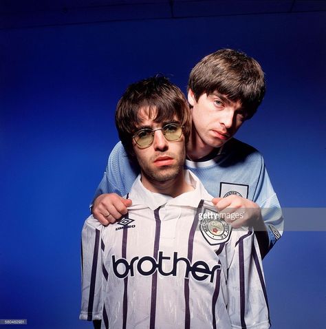 Oasis singer Liam Gallagher (left) and his brother, guitarist Noel Gallagher (right), of British rock group Oasis, Portsmouth, 9th May 1994. Both are sporting Manchester City shirts. Liam Gallagher 1994, Liam Gallagher Noel Gallagher, Supersonic Oasis, Champagne Supernova, Good Luck Today, Liam Gallagher Oasis, Liam And Noel, Oasis Band, Manchester City Football Club