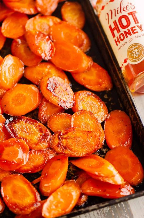 These Hot Honey Roasted Carrots are caramelized to perfection with a hint of spice from the chili infused honey. It's the perfect blend of sweet and spicy for a delicious side dish recipe. Hot Honey Dishes, Hot Honey Vegetables, Hot Honey Potatoes, Sweet And Spicy Roasted Carrots, Honey Garlic Carrots Recipe, Hot Honey Glazed Carrots, Honey Dill Carrots, Fall Veggie Sides, Sweet And Spicy Carrots