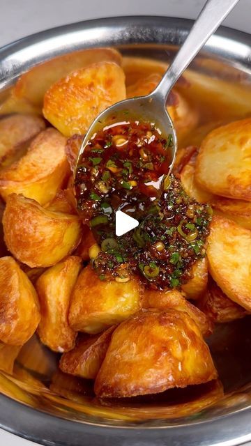 Sam Stern on Instagram: "Chilli, garlic & honey roast potatoes! 
These are a delicious variation on the classic roast potatoes. The sweet & spicy garlic sauce goes so well with the buttery crunch of the roast potatoes. Who wants one? 
Recipe:
1.5kg maris pipers, peeled and cut into even chunks 
Salt
1/2 tsp bicarbonate of soda 
Olive oil

1 tbsp crushed garlic
3 tbsp chilli crisp- I used Lao Gan Ma brand
1 1/2 tbsp honey 
1 1/2 tbsp light soy sauce 
1 tbsp rice vinegar 
2-3 spring onions, finely sliced 
A handful of coriander, finely sliced 

1. Preheat your oven to 190c fan.
2. Add the potatoes to a large pan of cold water. Add salt, bicarb and bring to the boil. Boil until a knife slips through easily, around 10-15 minutes. Drain and allow to steam dry.
3. Pour a generous amount of oil i Boil Potatoes Recipes, Honey Garlic Potatoes, Boiled Potato Recipes, Boiled Potatoes Recipe, Chilli Crisp, Spicy Garlic Sauce, Classic Roast, Steamed Potatoes, Garlic Honey