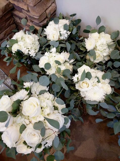 White bridal and bridesmaid bouquets with playa blanca roses, china mums, hydrangea, and bridal white mini carnations, and eucalyptus greens White Rose And Eucalyptus Bouquet Simple, Carnation And Eucalyptus Bouquet, Eucalyptus And Carnations Bouquet, White Carnations And Eucalyptus, White Roses And Carnations Bouquet, White Rose And Carnation Bouquet, Carnation Eucalyptus Bouquet, White Hydrangea And Eucalyptus Bouquet, Wedding Bouquets Carnations