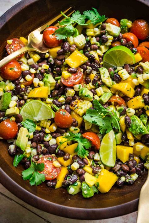 Our black bean mango salad with grilled corn and a jalapeño lime vinaigrette is a delicious summer side dish. Perfect for serving alongside your favorite grilled entree (vegan or not), as an appetizer, or as a salsa for tacos. Salsa For Tacos, Salad With Grilled Corn, Black Bean Avocado Salad, Tofu Kebab, Monthly Meals, Spring Potato, Bean Salads, Meal Rotation, Summer Side Dish