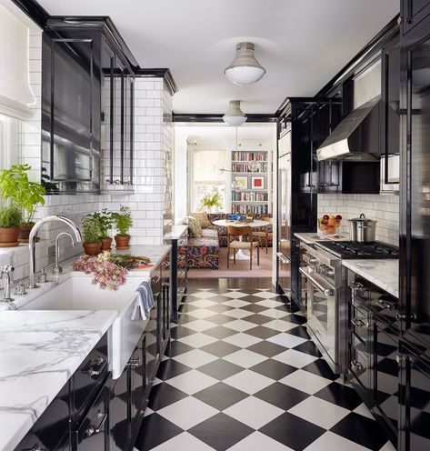 a long galley kitchen, black and white kitchen, black cabinets, kitchen inspo, kitchen ideas, marble countertops, farmhouse sink, white tile backsplash Black Galley Kitchen, Long Galley Kitchen, Sam Mitchell, Checkered Floor, Galley Kitchens, Galley Kitchen, Kitchen Farmhouse, Painted Floors, Mug Design